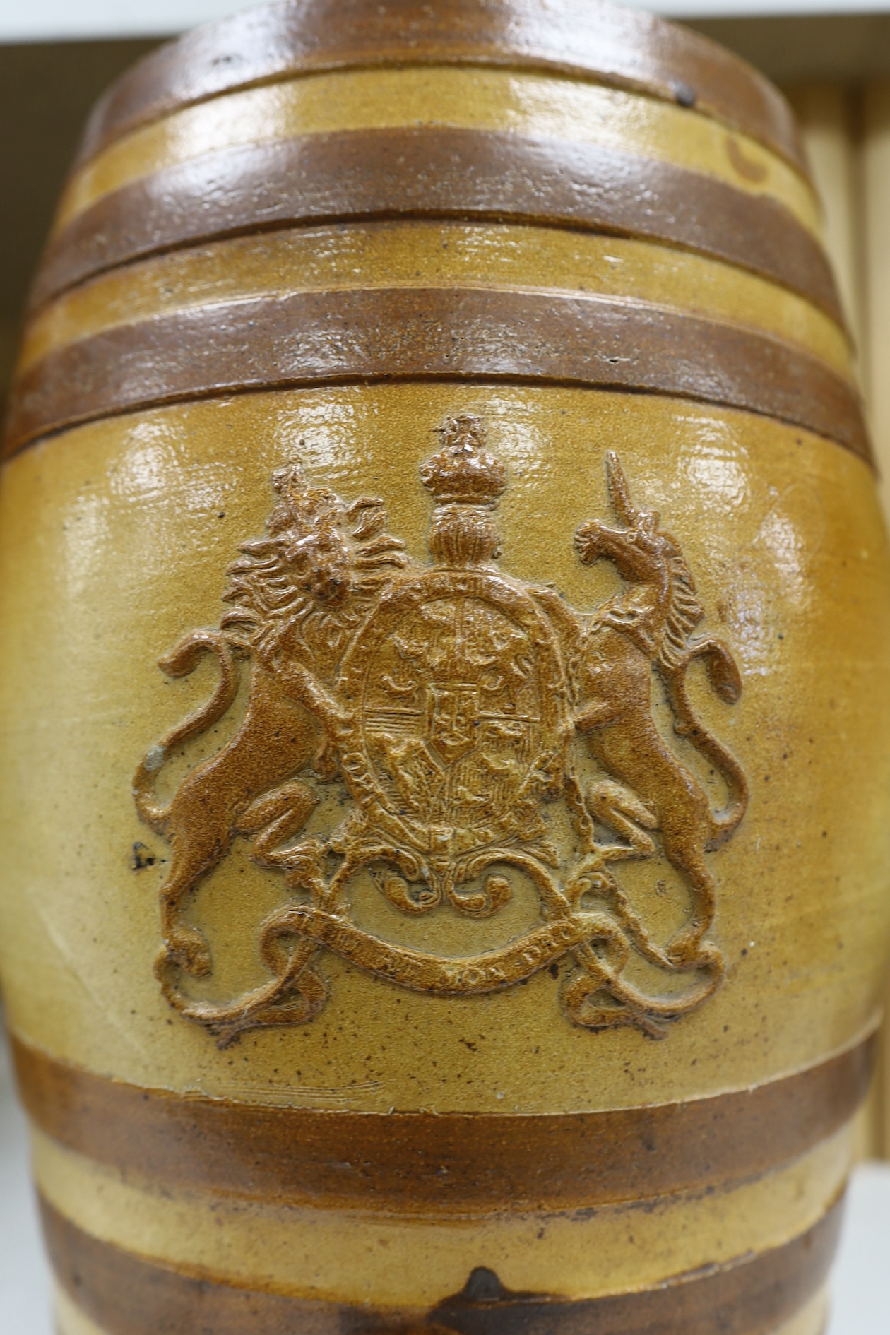 A Doulton and Watts stoneware spirit barrel, applied with the Royal coat of arms, 33.5cm high. Condition - some scratches in the glazing and marks on band by tap aperture